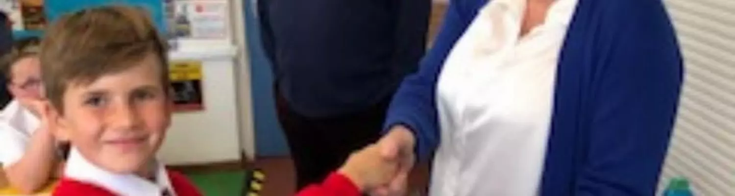 Penelope receiving a donation from one of the pupils